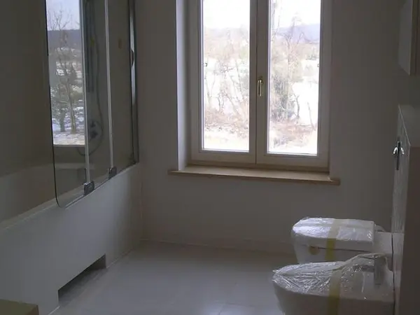 Łazienka po remoncie z oknem i białą armaturą